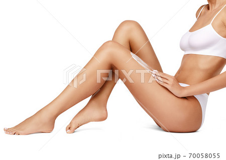 Slim woman's legs isolated on white background 70058055