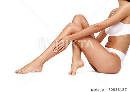 Slim woman's legs isolated on white background Slim woman's legs isolated on white background 70058127