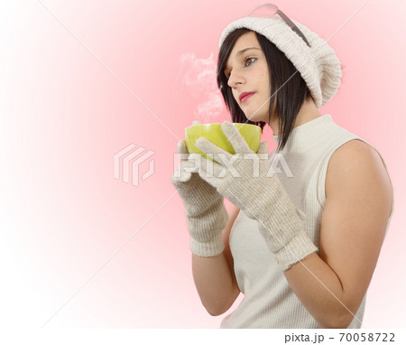 pretty young brunette woman with a cup of tea 70058722