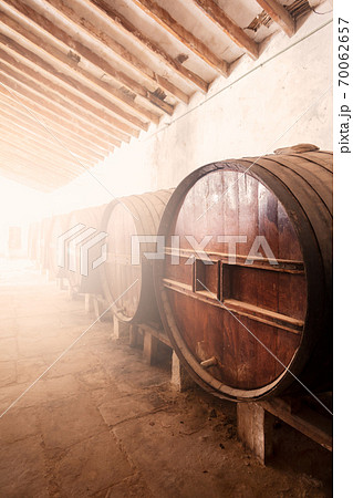 Wine barrels stacked in the old cellar of the vinery in Spain Wine barrels stacked in the old cellar of the vinery in Spain 70062657