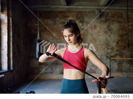 Young female boxer preparing for boxing fight Young female boxer preparing for boxing fight 70064093