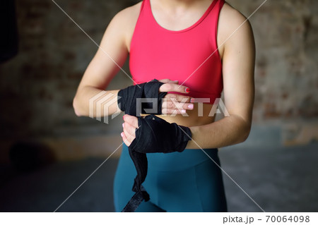 Young female boxer preparing for boxing fight. Young female boxer preparing for boxing fight. 70064098