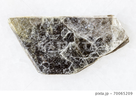 rough muscovite (common mica) on white marble 70065209