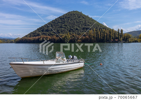 The Boat on the lake - Piediluco, pyramid island in the background. Umbria, Italy The Boat on the lake - Piediluco, pyramid island in the background. Umbria, Italy 70065667