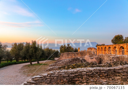 Scenic ruins in the rays of sunset of Grottoes of Catullus, roman villa in Sirmione city, Garda Scenic ruins in the rays of sunset of Grottoes of Catullus, roman villa in Sirmione city, Garda 70067135