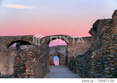 Scenic ruins in the rays of sunset of Grottoes of Catullus, roman villa in Sirmione city, Garda Scenic ruins in the rays of sunset of Grottoes of Catullus, roman villa in Sirmione city, Garda 70067136