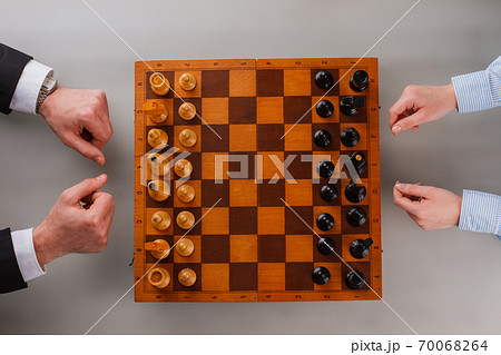 Top view of male and female hands with chess board. Top view of male and female hands with chess board. 70068264