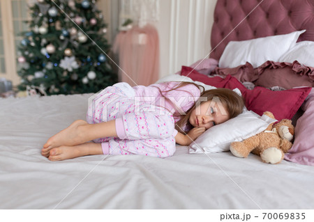 The little girl doesn't want to go to bed on Christmas night. Christmas tale. Magic moments of happy childhood 70069835