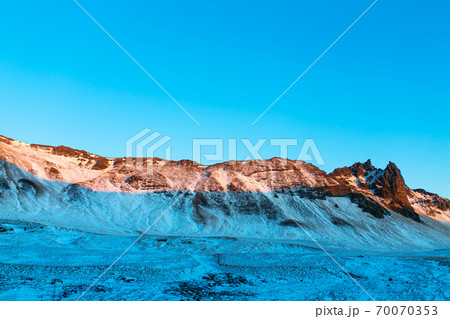 Iceland's incredible mountain landscape in winter. Mountains in the snow. Large spaces. The beauty of winter nature Iceland's incredible mountain landscape in winter. Mountains in the snow. Large spaces. The beauty of winter nature 70070353