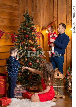 Happy family spend Christmas at home. Family holidays, Christmas tale. Best childhood memories Happy family spend Christmas at home. Family holidays, Christmas tale. Best childhood memories 70070412