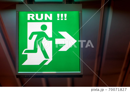The emergency exit sign RUN! shows the direction of escape in case of danger. The emergency exit sign RUN! shows the direction of escape in case of danger. 70071827