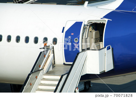 A stairs are ready under the open rear door of the aircraft, after landing. A stairs are ready under the open rear door of the aircraft, after landing. 70071828