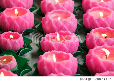 Detail of burning candles in the shape of a flower in a Buddhist monastery. Detail of burning candles in the shape of a flower in a Buddhist monastery. 70073417
