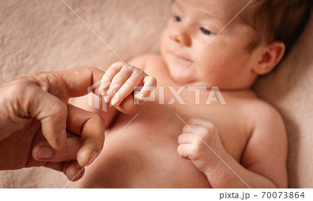 Portrait of a baby boy on a beige background. Portrait of a baby boy on a beige background. 70073864