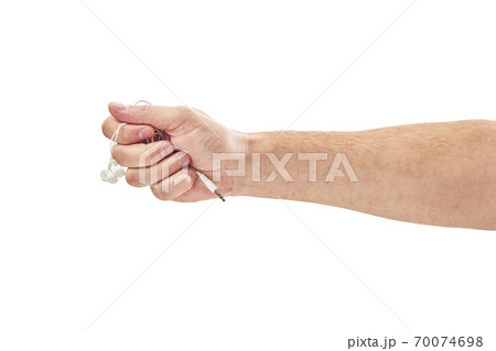 male hands are holding white headphones isolated on white 70074698