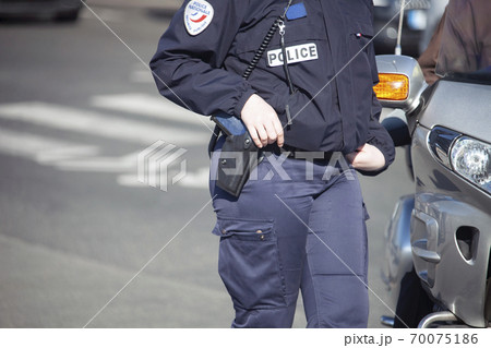 Female police officer controls traffic in the city. Female police officer controls traffic in the city. 70075186