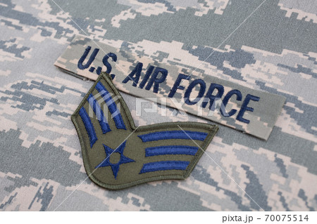 August 31, 2020. US AIR FORCE branch tape and Senior Airman rank patch on digital tiger-stripe pattern Airman Battle Uniform (ABU) background August 31, 2020. US AIR FORCE branch tape and Senior Airman rank patch on digital tiger-stripe pattern Airman Battle Uniform (ABU) background 70075514