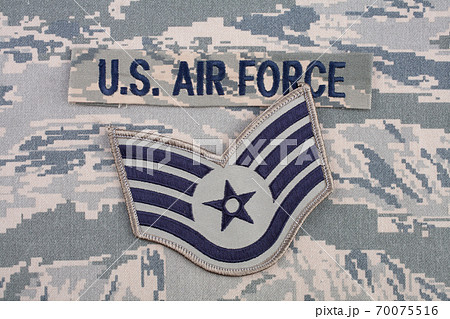 August 31, 2020. US AIR FORCE branch tape and Staff Sergeant rank patch on digital tiger-stripe pattern Airman Battle Uniform (ABU) background August 31, 2020. US AIR FORCE branch tape and Staff Sergeant rank patch on digital tiger-stripe pattern Airman Battle Uniform (ABU) background 70075516