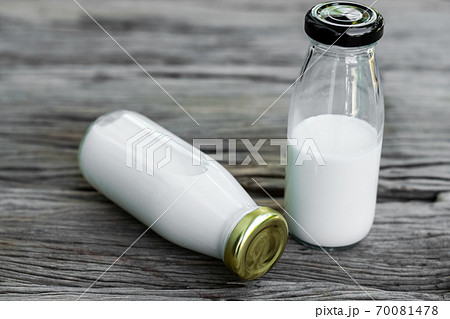 Bottle of fresh milk on an old wood background. 70081478