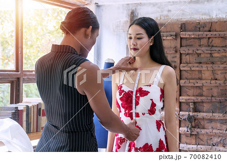 Dressmaker measuring body young woman in the studio. Dressmaker measuring body young woman in the studio. 70082410