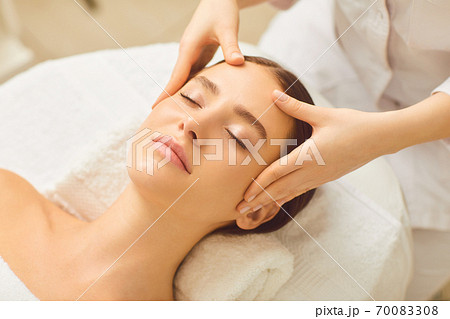 Beautiful girl has a facial massage in a beauty clinic. 70083308