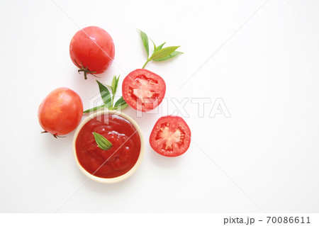 Bowl of ketchup or tomatoes sauce with ingredients on white background. Bowl of ketchup or tomatoes sauce with ingredients on white background. 70086611