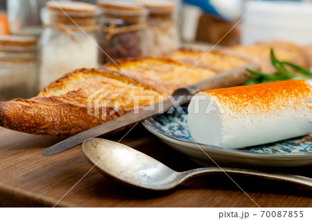 French cheese and fresh baguette on a wood cutter French cheese and fresh baguette on a wood cutter 70087855