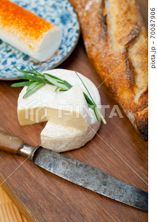 French cheese and fresh  baguette on a wood cutter 70087906