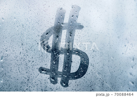 Abstract dollar sign as a symbol of wealth on a misted window 70088464