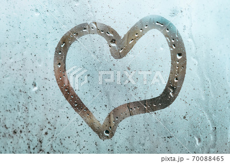 Abstract heart as a symbol of love on a misted window 70088465