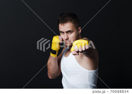 Sportsman muay thai man boxer stance at black background 70088834