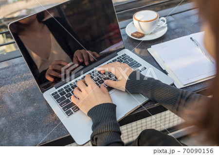 Woman hands working on laptop Woman hands working on laptop 70090156