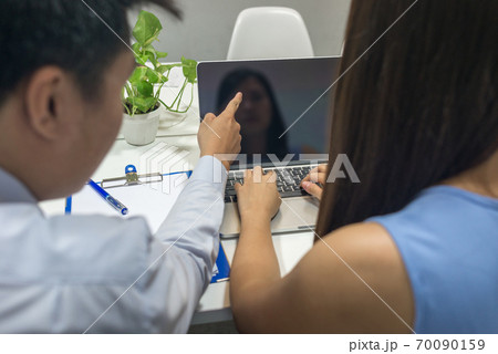 Rear view of business people discuss about data on laptop Rear view of business people discuss about data on laptop 70090159