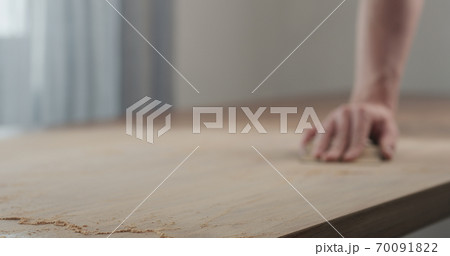 man hand sanding black walnut wood table man hand sanding black walnut wood table 70091822