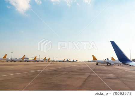 Wings and tails of Comercial airplanes parking at the airport and preparing for flight. Transportation concept. 70092572