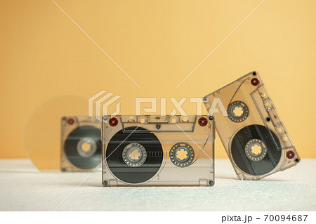 Beautiful Audio cassettes tape on a white table and yellow space.Minimalism retro style concept. 80s. Background pattern for design. 70094687