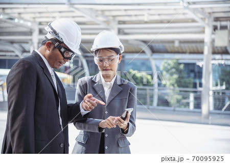 Construction engineer in Safety Suit Trust Team Holding White Yellow Safety hard hat Security Construction engineer in Safety Suit Trust Team Holding White Yellow Safety hard hat Security 70095925