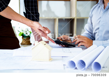Engineers or architects are meeting a team to design the architectural structure in the design with blueprints and model buildings in working site, Technological structure and construction Concept. Engineers or architects are meeting a team to design the architectural structure in the design with blueprints and model buildings in working site, Technological structure and construction Concept. 70096309