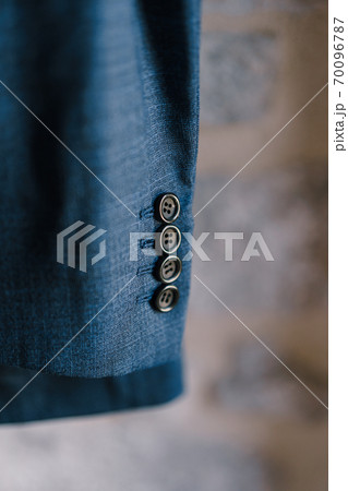 Close-up of buttons on the sleeve of a men's blue jacket, shallow depth of field. Close-up of buttons on the sleeve of a men's blue jacket, shallow depth of field. 70096787