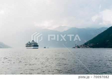 The cruise liner sails near the city of Perast and the islands in Montenegro. The cruise liner sails near the city of Perast and the islands in Montenegro. 70097082
