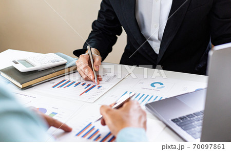 Meeting a team of businessmen, Executives and accountants meeting about the company's revenue graph in the office with laptops and calculators, Finance concept. Meeting a team of businessmen, Executives and accountants meeting about the company's revenue graph in the office with laptops and calculators, Finance concept. 70097861