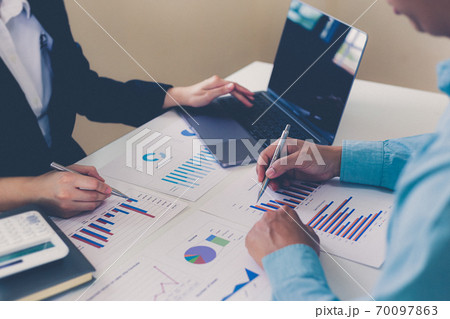 Meeting a team of businessmen, Executives and accountants meeting about the company's revenue graph in the office with laptops and calculators, Finance concept. Meeting a team of businessmen, Executives and accountants meeting about the company's revenue graph in the office with laptops and calculators, Finance concept. 70097863