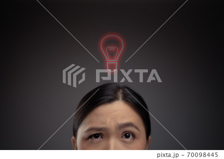 Unhappy Asian woman and red lightbulb icon hologram effect. 70098445
