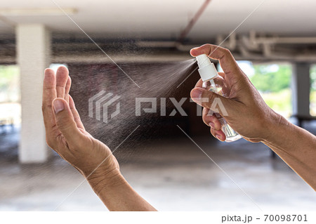 Man uses a spray of alcohol to get rid of bacteria and viruses, Inhibition and prevention of Covid-19 virus, protect virus concept. 70098701