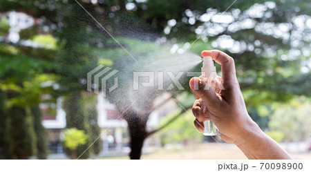 Man uses a spray of alcohol to get rid of bacteria and viruses, Inhibition and prevention of Covid-19 virus, protect virus concept. Man uses a spray of alcohol to get rid of bacteria and viruses, Inhibition and prevention of Covid-19 virus, protect virus concept. 70098900