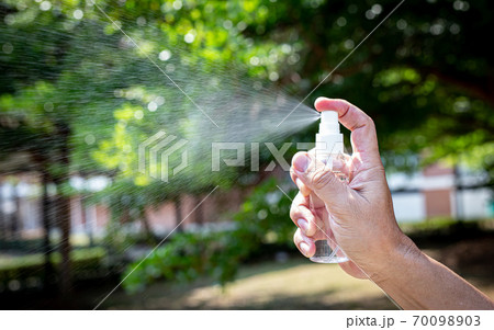 Man uses a spray of alcohol to get rid of bacteria and viruses, Inhibition and prevention of Covid-19 virus, protect virus concept. 70098903