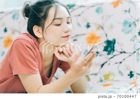 Woman lying on sofa 70100447