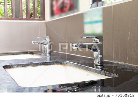 Public sinks, Handwashers for people using public toilets, Public toilets and hygiene concept. 70100818