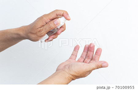 Man uses a spray of alcohol to get rid of bacteria and viruses, Inhibition and prevention of Covid-19 virus, protect virus concept. Man uses a spray of alcohol to get rid of bacteria and viruses, Inhibition and prevention of Covid-19 virus, protect virus concept. 70100955