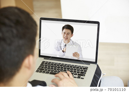 young asian man receiving a diagnosis using tele-medicine network 70101110